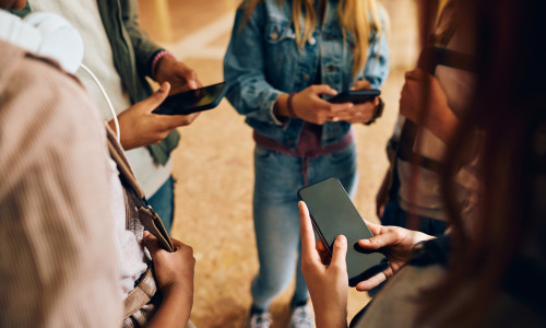 Close,Up,Of,High,School,Students,Using,Smart,Phones,In