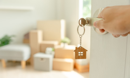 Moving,House,,Relocation.,Man,Hold,Key,House,Keychain,In,New