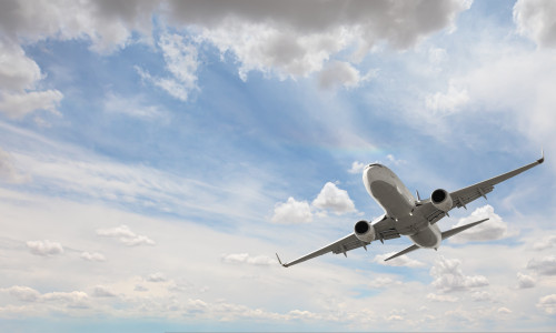 White,Passenger,Airplane,Flying,In,The,Sky,Amazing,Clouds,In