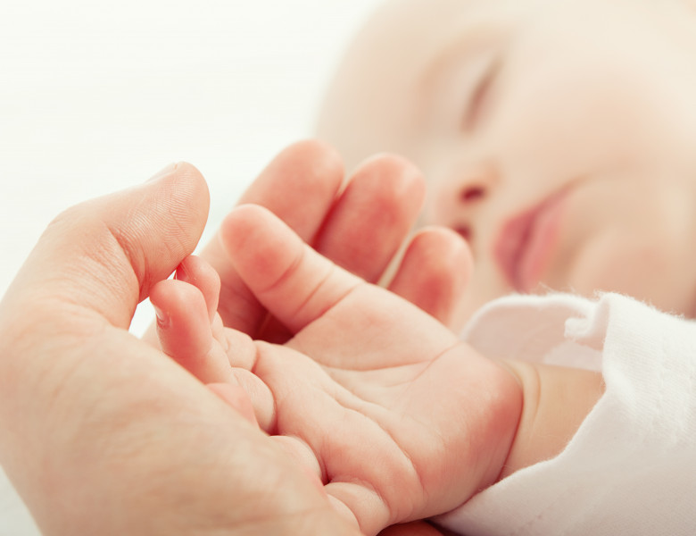 Hand,The,Sleeping,Baby,In,The,Hand,Of,Mother,Close-up