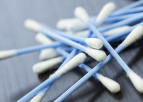 Cotton swabs in blue with white cotton wool as a close-up