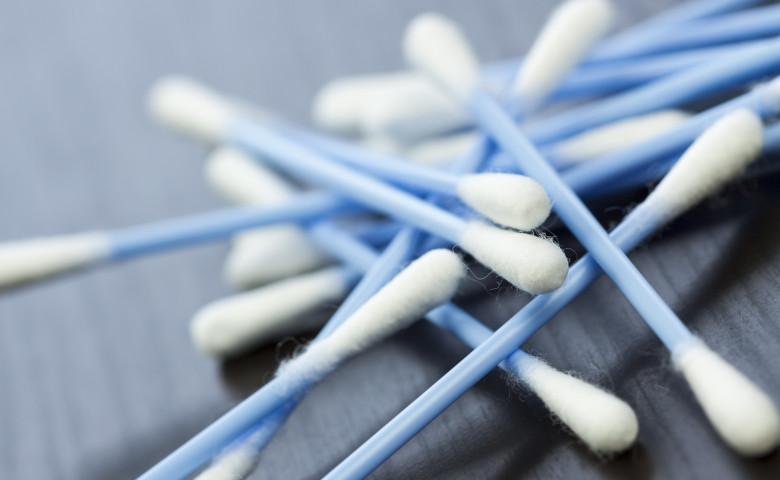 Cotton swabs in blue with white cotton wool as a close-up