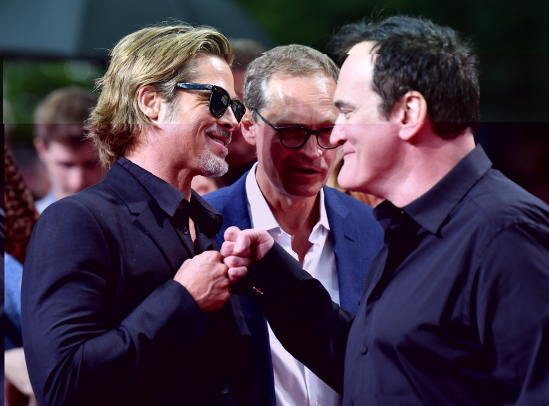 Berlin, Germany. 01st Aug, 2019. US director Quentin Tarantino (r) and actor Brad Pitt (l) welcome each other before the premiere of their movie "Once upon a time.in Hollywood". Between them stands Berlin's Governing Mayor Michael Mller (SPD). The Hollywo