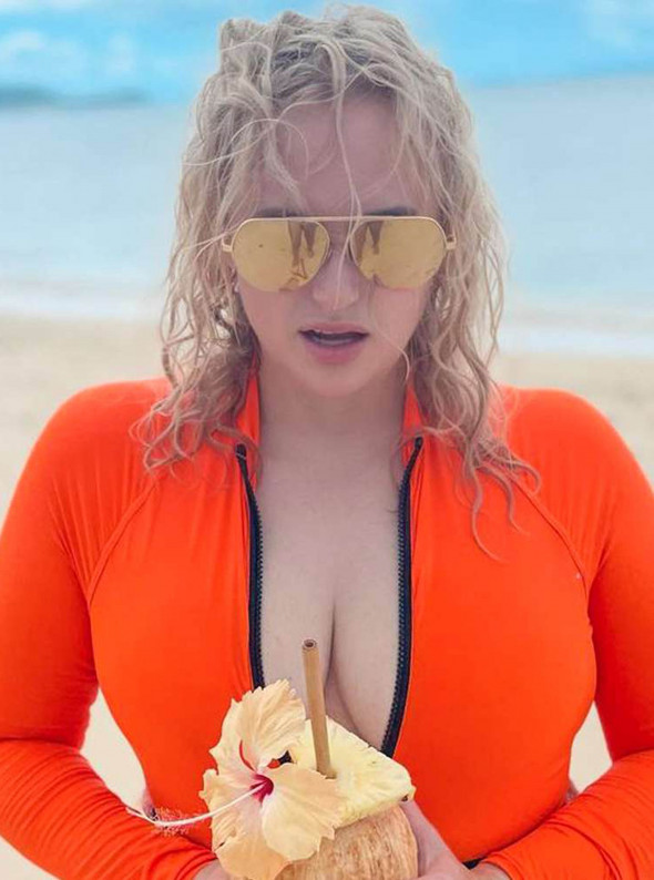 Rebel Wilson Hits the Beach in Neon Orange Swimsuit During Tropical Vacation: 'Find Me in Fiji'
