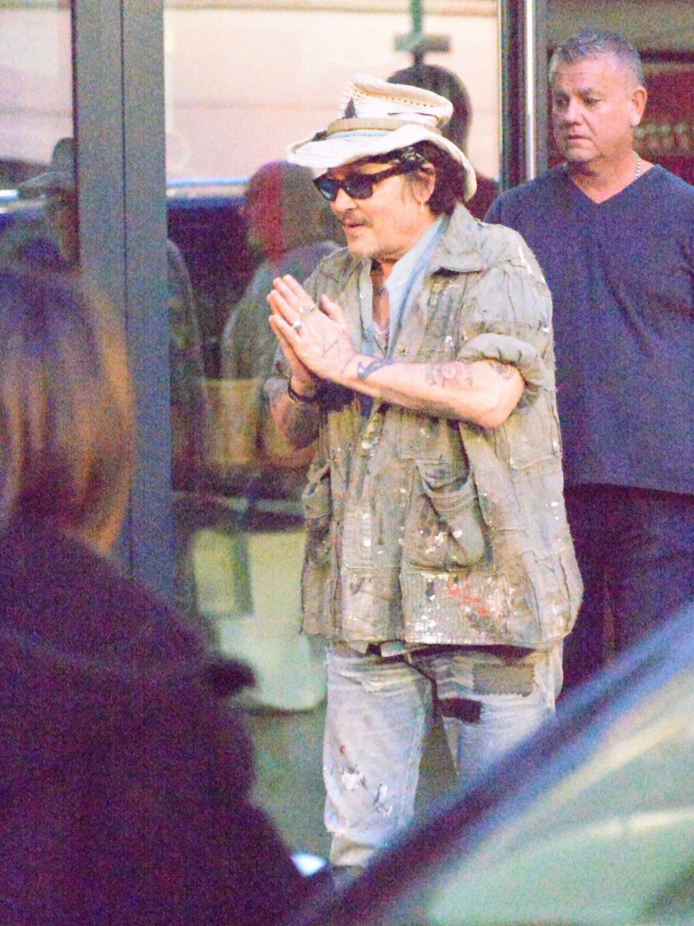 *EXCLUSIVE* Howdy! Johnny Depp toffs his hat as a sign of respect to his loyal fans who were waiting for him as he left his hotel out in London.