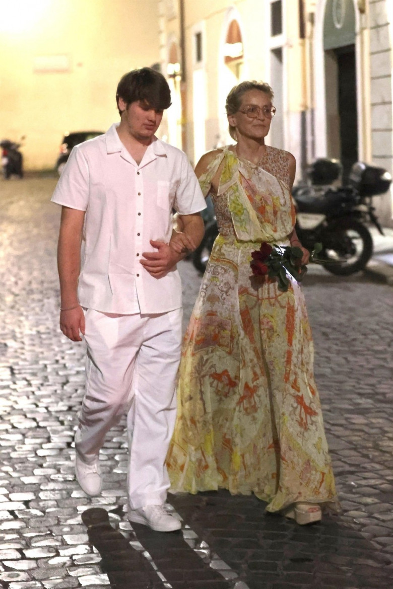 *EXCLUSIVE* The American Actress Sharon Stone looks in great spirits as she enjoys a spot of dinner with Gabriele Israilovici and son Laird at Dal Bolognese restaurant during a visit to the eternal city of Rome.