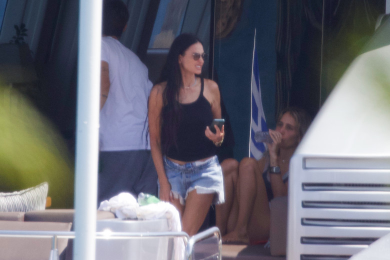 *EXCLUSIVE* Fun in the Grecian sun!! 61-year-old Demi Moore soaks up the sun in denim shorts while vacationing in Greece with her girlfriends and dog Pilaf!