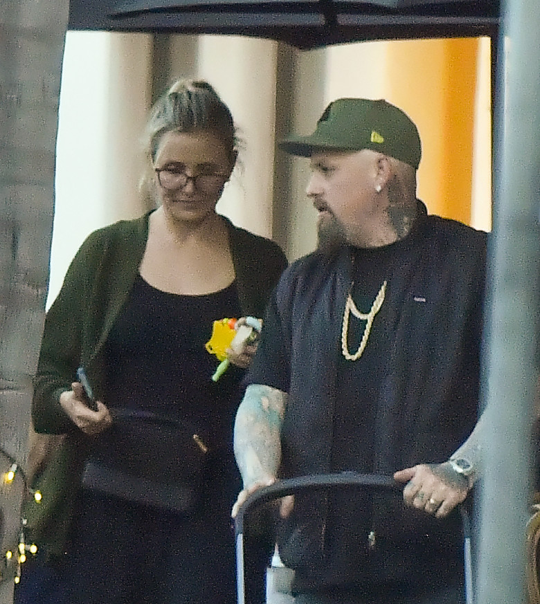 EXCLUSIVE: Cameron Diaz and husband Benji Madden share a sweet kiss as they leave a restaurant in Montecito Ca