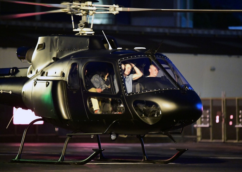 *EXCLUSIVE* WEB MUST CALL FOR PRICING  - Piloting a few friends on his chopper, The American All Action Hero Tom Cruise proves he has many strings to his bow by taking a few snaps of his guests as he arrived at the Battersea Heliport.