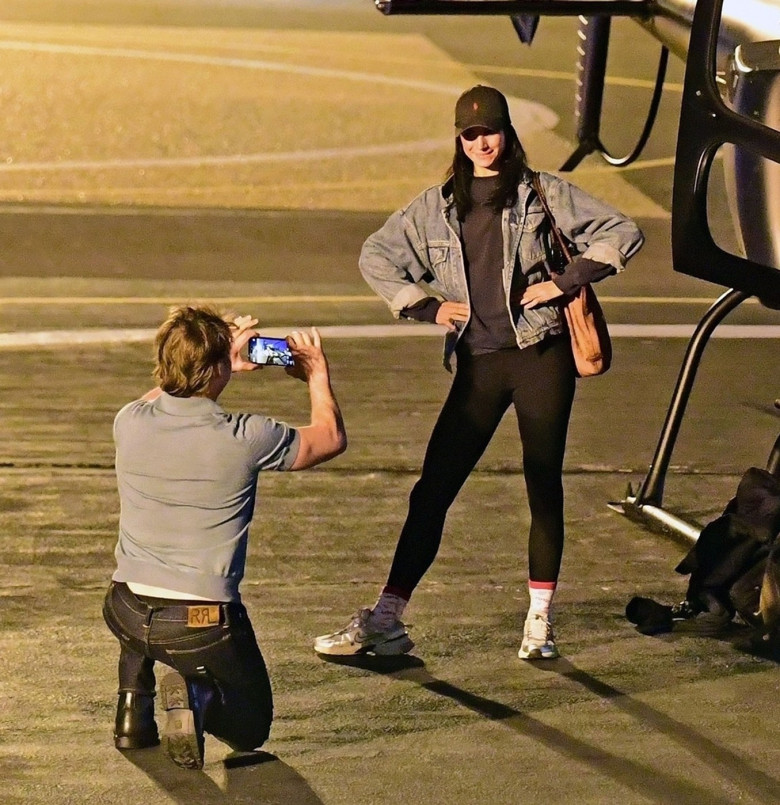 *EXCLUSIVE* WEB MUST CALL FOR PRICING  - Piloting a few friends on his chopper, The American All Action Hero Tom Cruise proves he has many strings to his bow by taking a few snaps of his guests as he arrived at the Battersea Heliport.