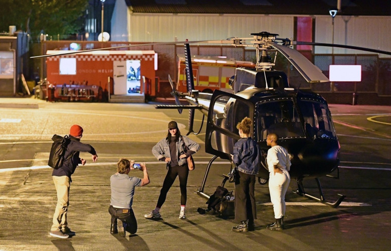 *EXCLUSIVE* WEB MUST CALL FOR PRICING  - Piloting a few friends on his chopper, The American All Action Hero Tom Cruise proves he has many strings to his bow by taking a few snaps of his guests as he arrived at the Battersea Heliport.