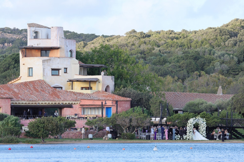 *PREMIUM-EXCLUSIVE* *MUST CALL FOR PRICING * Australian actress Rebel Wilson and her fashion designer fiancée Ramona Agruma look stunning in white wedding dresses as the couple are married in a beautiful ceremony at the Hotel Cala di Volpe in Sardinia