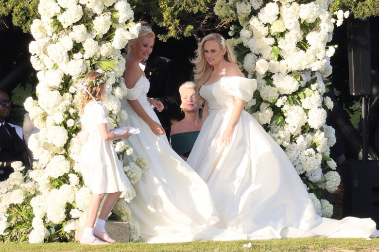 *PREMIUM-EXCLUSIVE* *MUST CALL FOR PRICING * Australian actress Rebel Wilson and her fashion designer fiancée Ramona Agruma look stunning in white wedding dresses as the couple are married in a beautiful ceremony at the Hotel Cala di Volpe in Sardinia