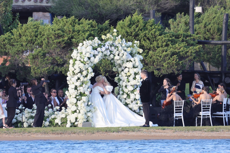 *PREMIUM-EXCLUSIVE* *MUST CALL FOR PRICING * Australian actress Rebel Wilson and her fashion designer fiancée Ramona Agruma look stunning in white wedding dresses as the couple are married in a beautiful ceremony at the Hotel Cala di Volpe in Sardinia