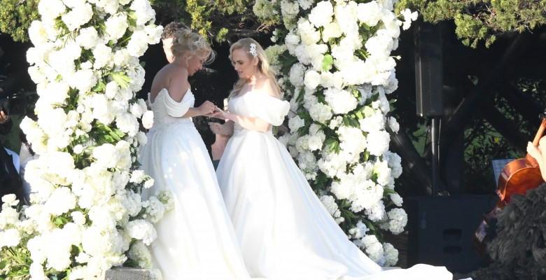 *PREMIUM-EXCLUSIVE* *MUST CALL FOR PRICING * Australian actress Rebel Wilson and her fashion designer fiancée Ramona Agruma look stunning in white wedding dresses as the couple are married in a beautiful ceremony at the Hotel Cala di Volpe in Sardinia