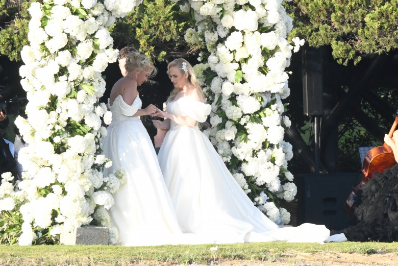 *PREMIUM-EXCLUSIVE* *MUST CALL FOR PRICING * Australian actress Rebel Wilson and her fashion designer fiancée Ramona Agruma look stunning in white wedding dresses as the couple are married in a beautiful ceremony at the Hotel Cala di Volpe in Sardinia