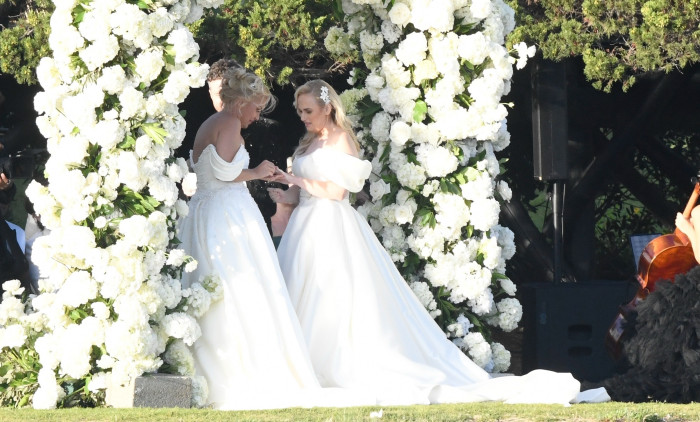 *PREMIUM-EXCLUSIVE* *MUST CALL FOR PRICING * Australian actress Rebel Wilson and her fashion designer fiancée Ramona Agruma look stunning in white wedding dresses as the couple are married in a beautiful ceremony at the Hotel Cala di Volpe in Sardinia