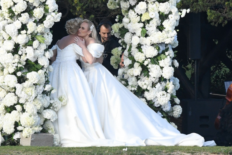 *PREMIUM-EXCLUSIVE* *MUST CALL FOR PRICING * Australian actress Rebel Wilson and her fashion designer fiancée Ramona Agruma look stunning in white wedding dresses as the couple are married in a beautiful ceremony at the Hotel Cala di Volpe in Sardinia