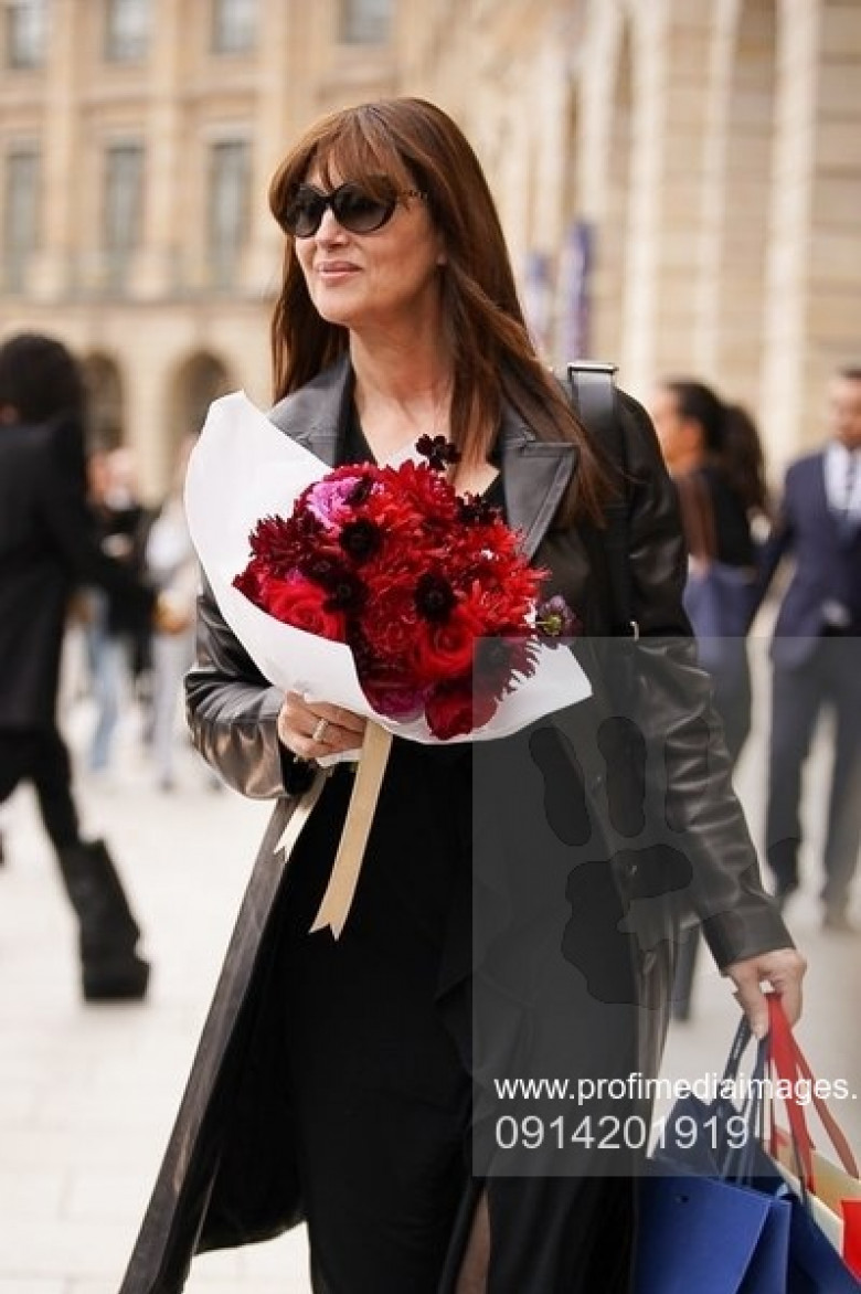 Monica Bellucci carries flowers while out in Paris