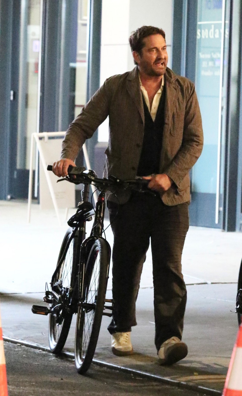 *EXCLUSIVE* Gerard Butler goes on a bike ride after having dinner with friends in NYC