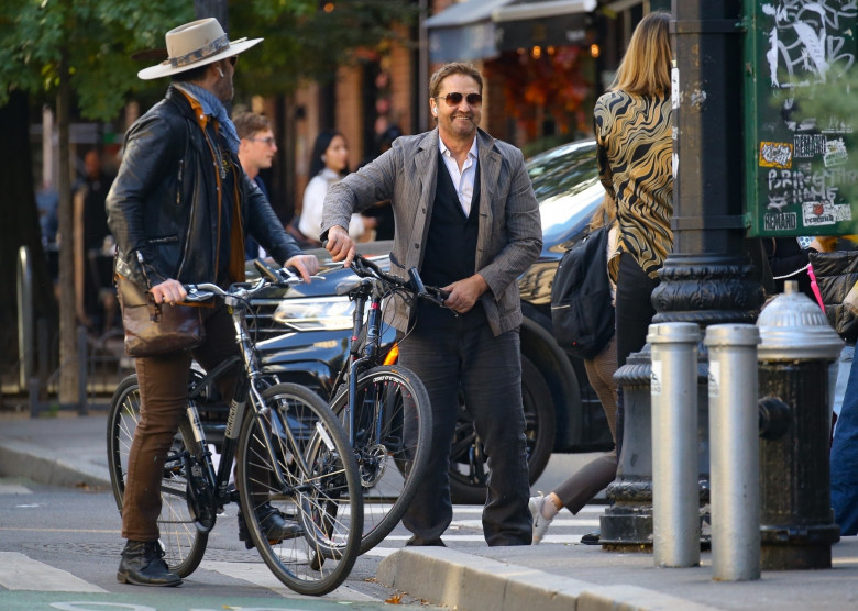 *EXCLUSIVE* Gerard Butler spotted biking through NYC with a friend