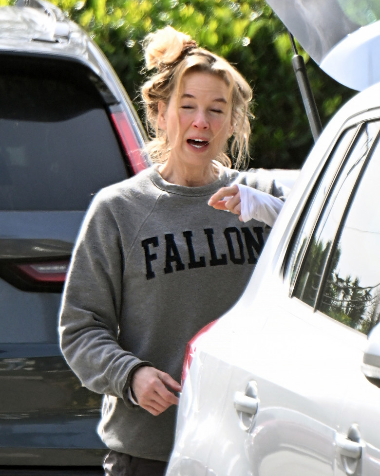 EXCLUSIVE: Renee Zellweger steps out with a messy head of hair after arriving home after doing a two week press tour around the world for her new movie