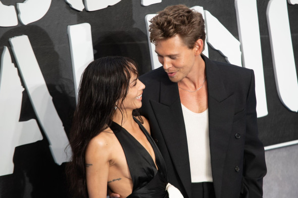 Zoe Kravitz and Austin Butler pose together for photographers at the premiere of "Caught Stealing" in London.