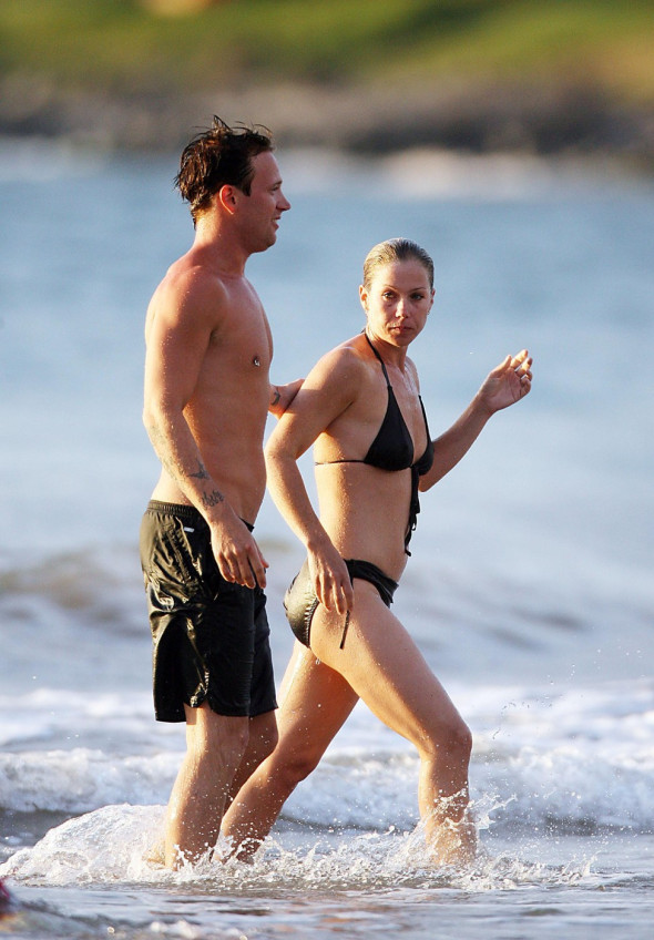 FILE PHOTO: Lee Grivas, the 26-year-old on and off boyfriend of Christina Applegate shown here on the beach in Hawaii with the actress, was found dead in his apartment