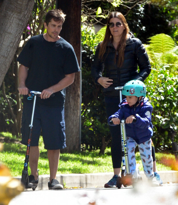 EXCLUSIVE: Actor Christian Bale And His Wife Sibi Are Seen In Their Brentwood, CA Neighborhood On Razor Scooters With Their Young Son Joseph During The Los Angeles Coronavirus Lockdown