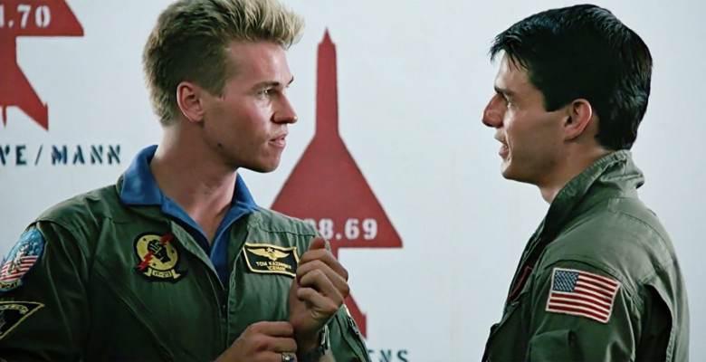 USA. Tom Cruise and Val Kilmer   in a scene from the ©Paramount Pictures cult movie: Top Gun (1986).Plot:  As students at the United States Navy's elite fighter weapons school compete to be best in the class, one daring young pilot learns a few things fr
