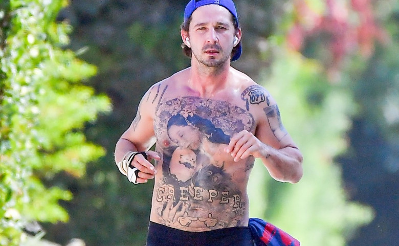 EXCLUSIVE: Shia LaBeouf still has an injured right hand as he takes a shirtless walk around his neighborhood