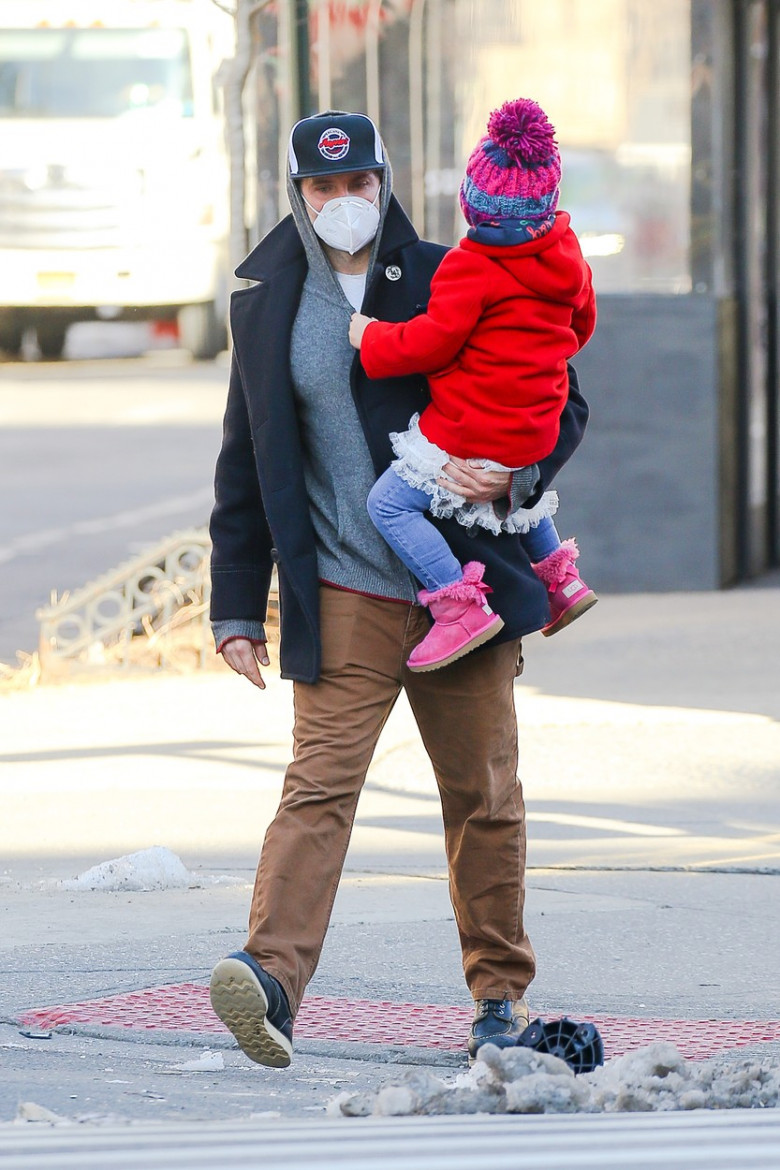 Bradley Cooper carries his daughter Lea while out and about in New York City