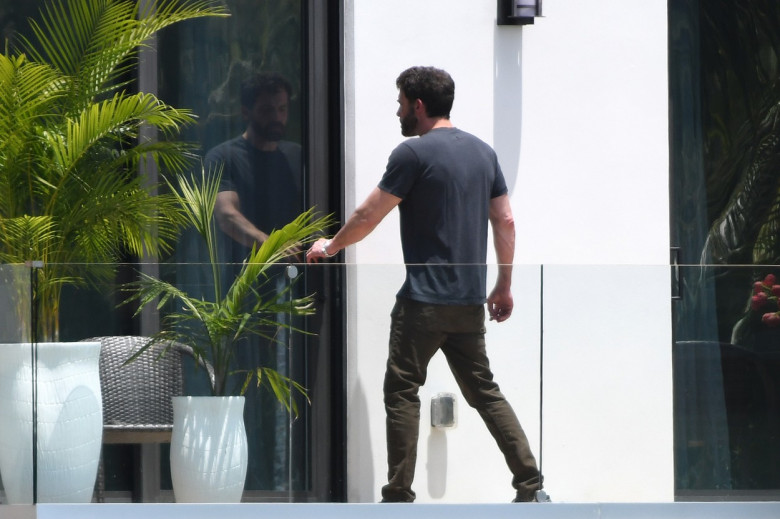 Jennifer Lopez and Ben Affleck are seen on the upstairs balcony of her rental home in Miami