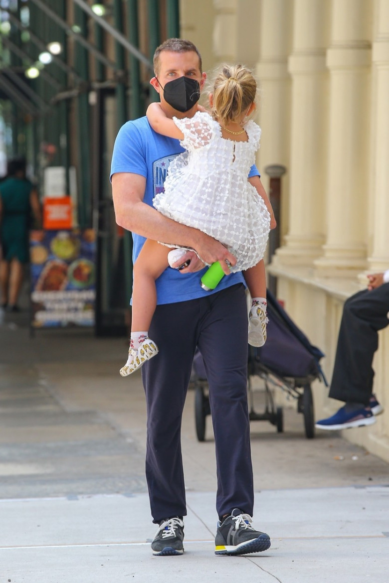 Bradley Cooper seen carrying his daughter as they take a stroll in NYC