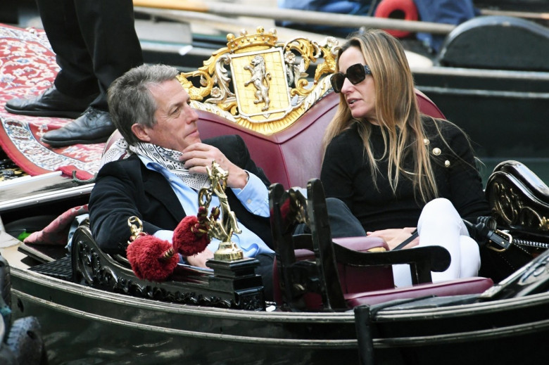 *PREMIUM-EXCLUSIVE* *MUST CALL FOR PRICING* - The British Actor Hugh Grant and wife Anna Elisabet Eberstein pictured looking relaxed and taking selfie's as they enjoy a romantic gondola ride on the Venetian waters on their holiday out in Venice.