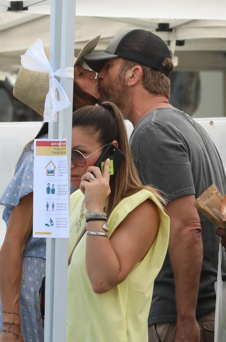 *EXCLUSIVE* Gerard Butler and Morgan Brown share a kiss at the Farmers Market