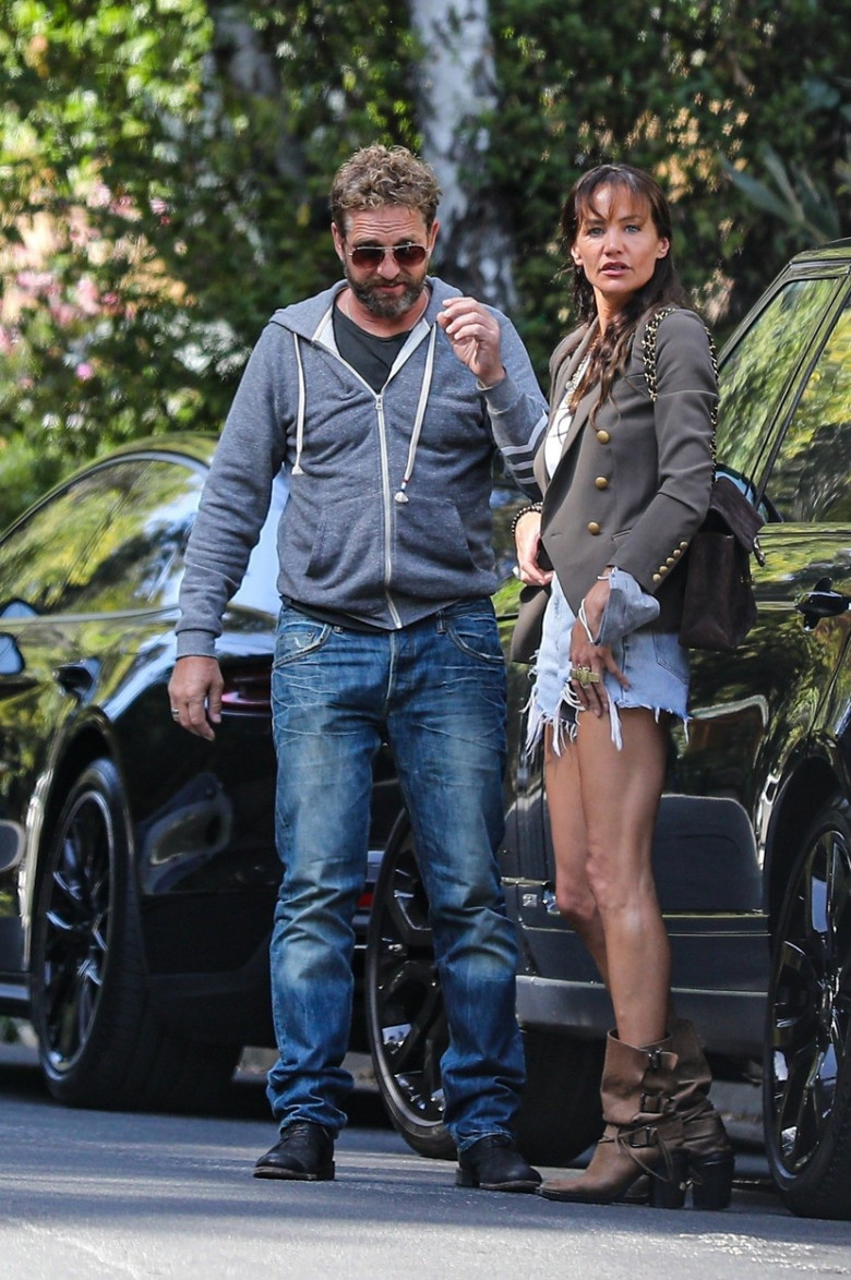 *EXCLUSIVE* Gerard Butler has steamy PDA session with GF Monica Brown after installing bike rack