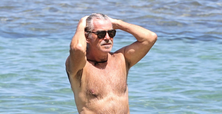 EXCLUSIVE: Pierce Brosnan takes off his shirt and takes a dip while in Hawaii