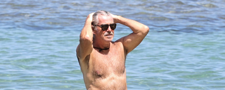 EXCLUSIVE: Pierce Brosnan takes off his shirt and takes a dip while in Hawaii