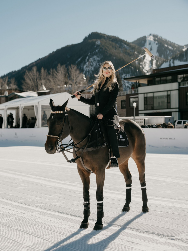 Kate Hudson poses on a horse and with a giant dog at the St. Regis World Snow Polo Championship in Aspen, Colorado