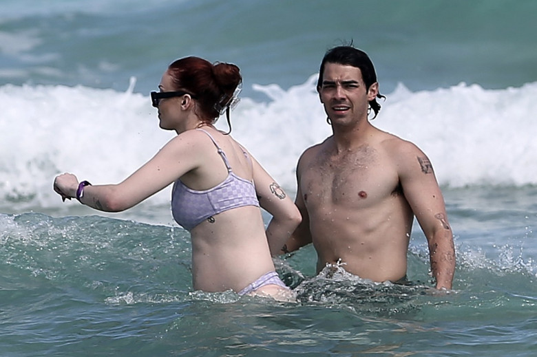 PREMIUM EXCLUSIVE:  A beaming Sophie Turner steps out in a bikini, proudly confirming she is pregnant with her second child