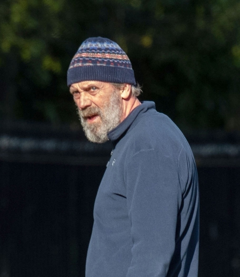 *EXCLUSIVE* *WEB MUST CALL FOR PRICING* Hugh Laurie looks unrecognisable in a tracksuit, a beanie hat and trainers and a full bushy beard as he was spotted taking his dog for a walk in London.