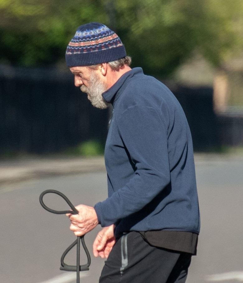 *EXCLUSIVE* *WEB MUST CALL FOR PRICING* Hugh Laurie looks unrecognisable in a tracksuit, a beanie hat and trainers and a full bushy beard as he was spotted taking his dog for a walk in London.