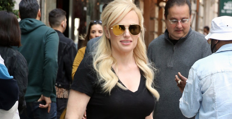 EXCLUSIVE: Rebel Wilson Heads To The Airport In A Casual Black Top, Pants And Flats - Carrying A Small Leather Tote, In New York City
