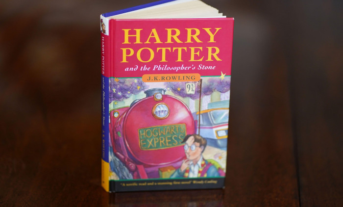 A pristine first edition hardback of JK Rowling's Harry Potter and the Philosopher's Stone, one of only 500 produced in the first print run in 1997, on display at Hansons' Auctioneers at Bishton Hall, Staffordshire. The book has never been read and was ke