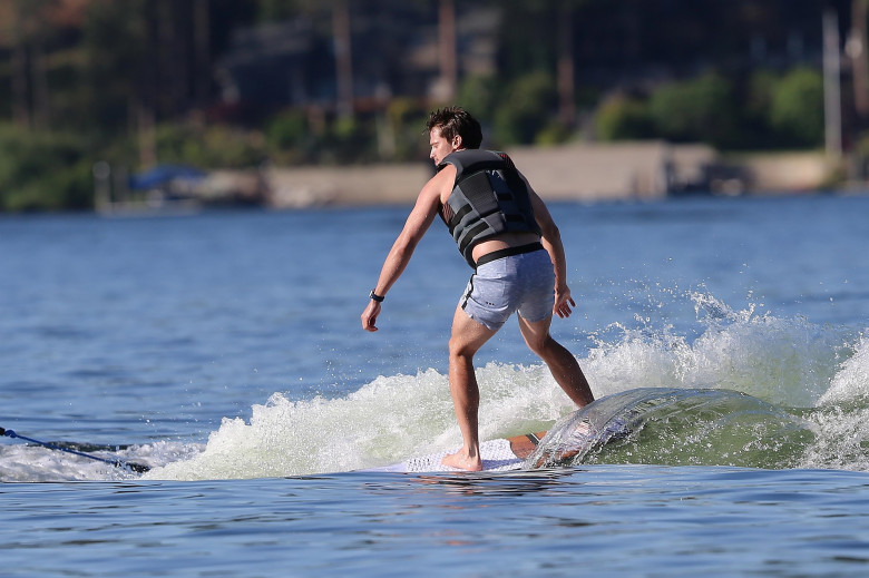*EXCLUSIVE* Patrick Schwarzenegger goes wake surfing over the  Fourth of July weekend while mom, Maria Shriver and friends ride on the boat