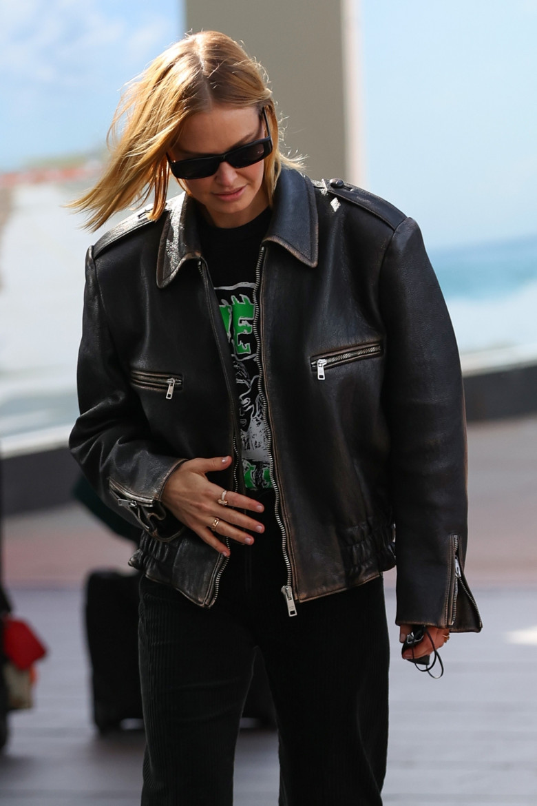 *EXCLUSIVE* “Lara Worthington arrives into Sydney Airport wearing a black Moto jacket and black pants”