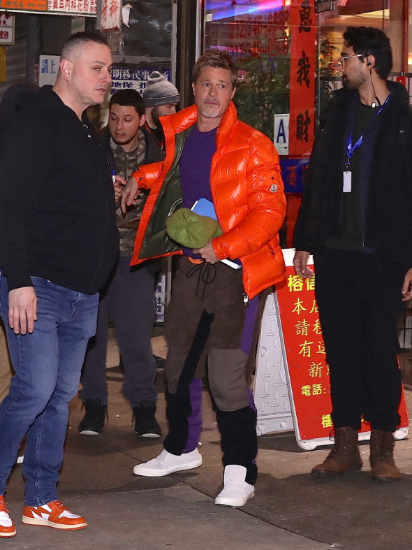 Brad Pitt signs autographs in orange bomber jacket as he heads to the makeup trailer on his 2nd day of filming with George Clooney in NYC
