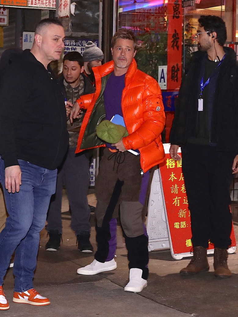 Brad Pitt signs autographs in orange bomber jacket as he heads to the makeup trailer on his 2nd day of filming with George Clooney in NYC