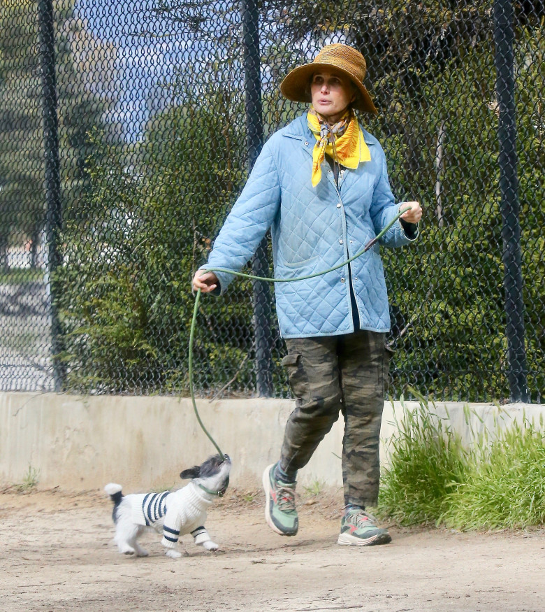 EXCLUSIVE: Actress Andie MacDowell is barely recognizable walking her pup at the Silverlake Reservoir walking trails